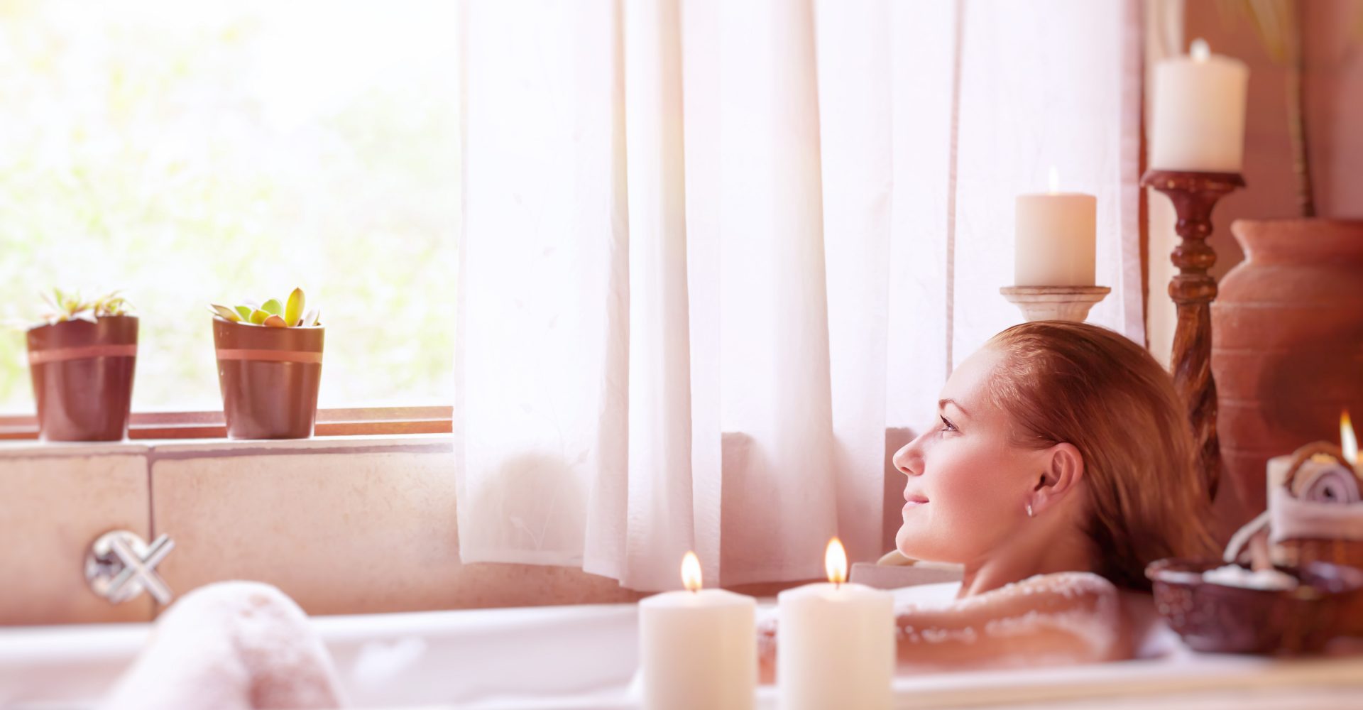 Beautiful girl spending time in the spa hotel, relaxing in the nice bath with foam, looking in the window, healthy treatment and enjoyment